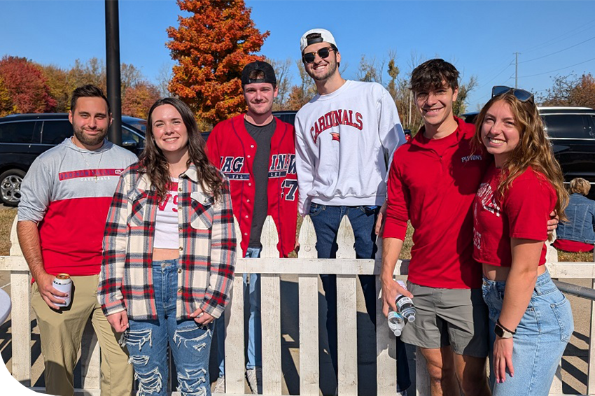 Group of young alumni smiling at homecoming